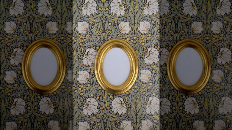 Gold frame on floral wallpaper