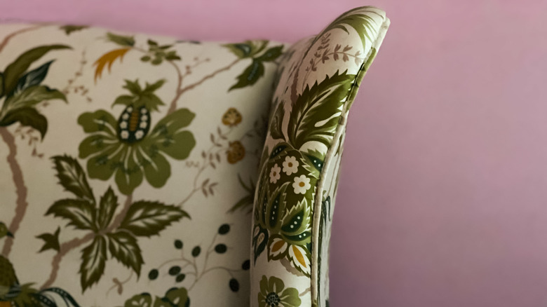 vintage upholstered chair segment against lavender wall