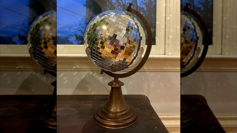 A spinning disco ball globe on a desk