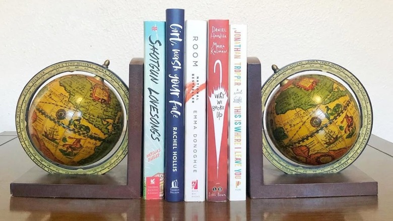 Two vintage globe bookends with books