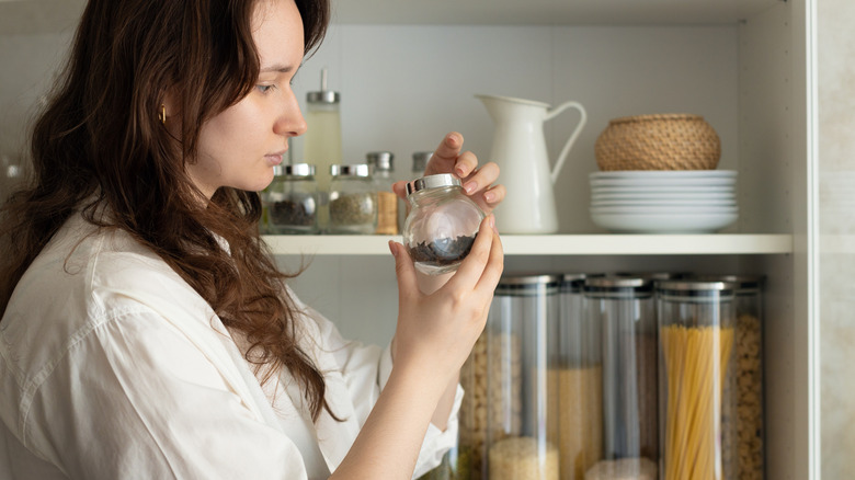 Woman decluttering pantry
