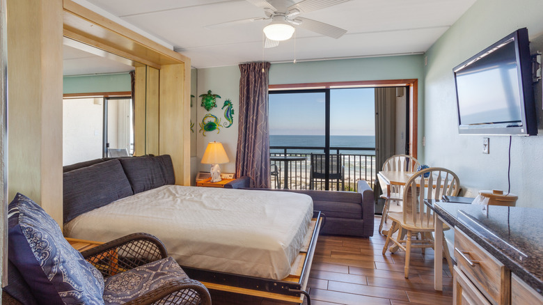 Murphy bed folded down in a small space with an ocean view