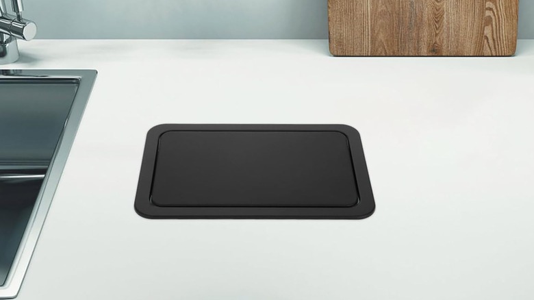 A garbage hatch built into a countertop