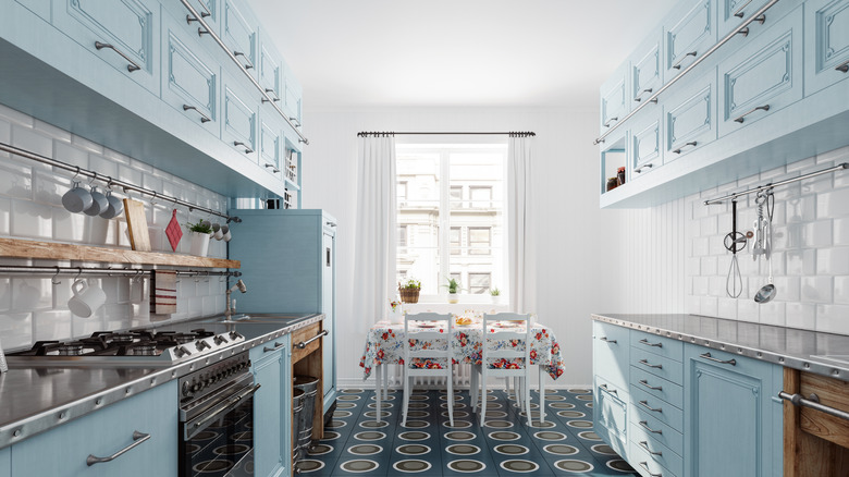 Retro kitchen with blue cabinets and stainless steel benchtops