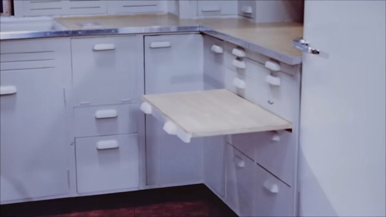 Pull-out lap board extended from a kitchen cabinet