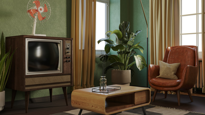 Retro-style living room with old tv, midcentury modern coffee table, and vintage leather chair