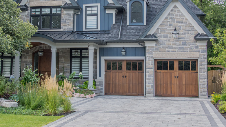 gray driveway with wooden garage