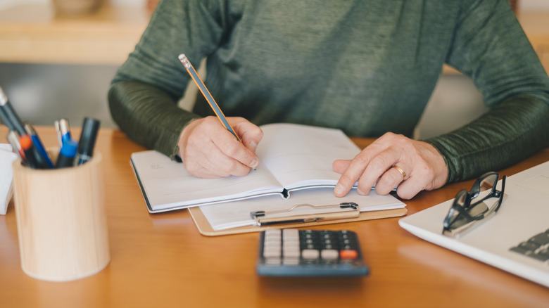 Woman making a budget and using a calculator