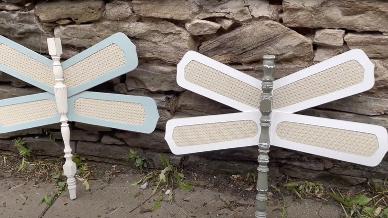 Dragonfly garden art made from porch railing spindles and ceiling fan blades.