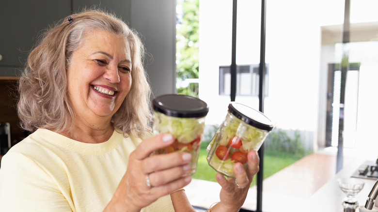 smiling woman looking at jars