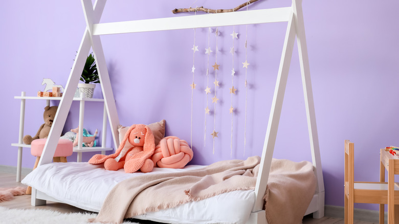 lilac bedroom with coral pillows