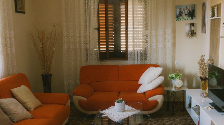 burnt orange couch with beige accents