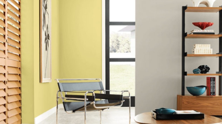 A living room with one wall painted beige and the other chartreuse