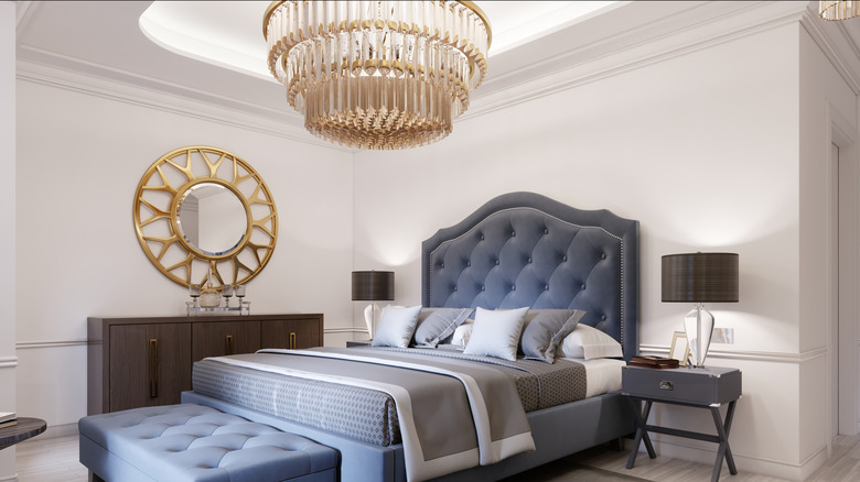 large chandelier above bed