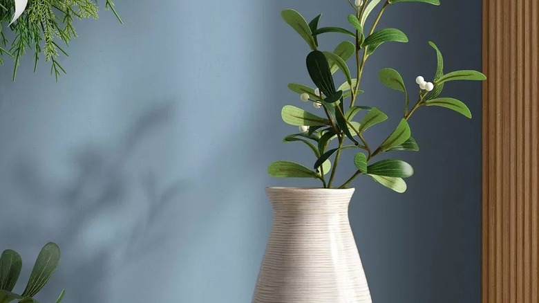 Faux stems in white vase