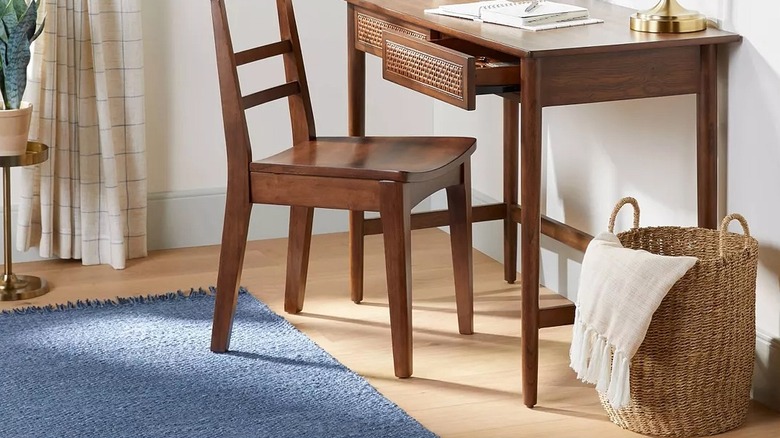 Woven basket next to a small desk and chair