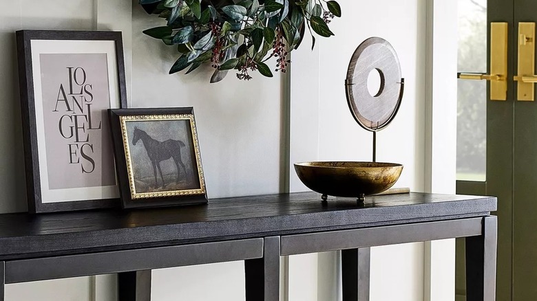 Horse print sitting on a table with other home decor