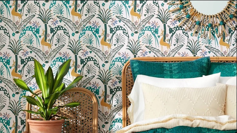 Colorful patterned wallpaper behind a bed