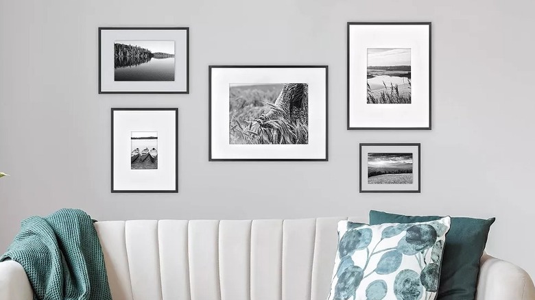 Black frames hanging on a living room wall