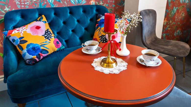 Ckoseup of a velvet sofa and red table