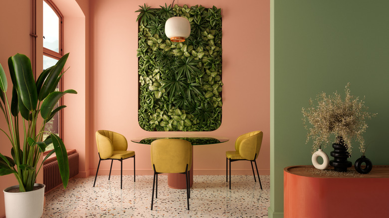 Wall cutout with lots of greenery near a table and chairs