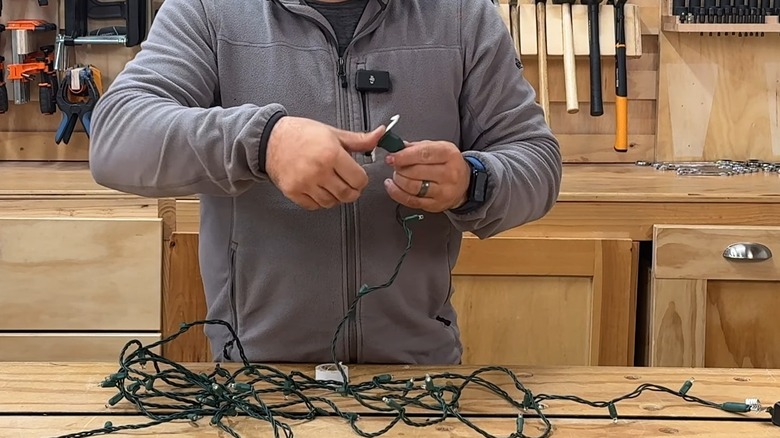 Applying a piece of white tape over the female part of a string light