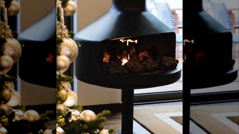A mirrored inset of a floating, black, midcentury modern fireplace.