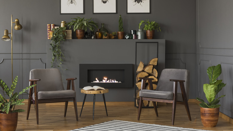 A living room painted with gray walls and a modern fireplace and wooden decor.