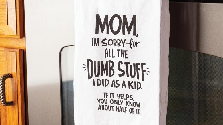 A white tea towel with a funny declaration from a kid