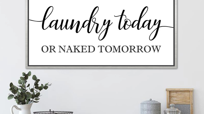 Funny laundry sign on a wood board