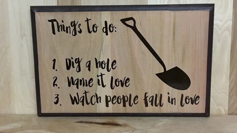 A funny wood sign against a wooden background