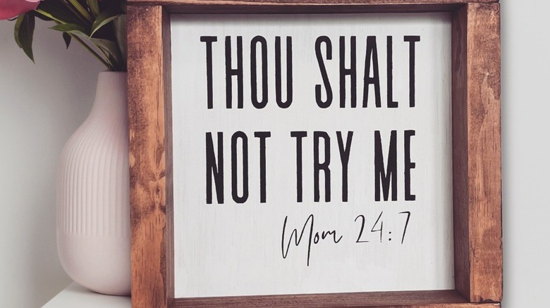 A menacing sign warning kids to not stress their mom