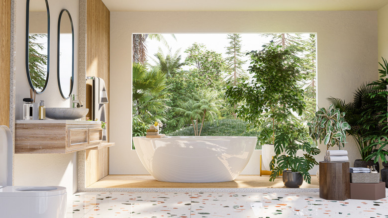 bathroom with tub and plants