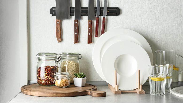 kitchen counter with glass jars and utensils