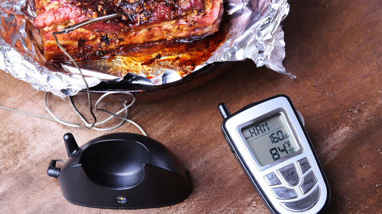 A wireless meat thermometer with a handheld digital remote.