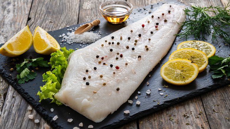 Raw fish on a black stone cutting board