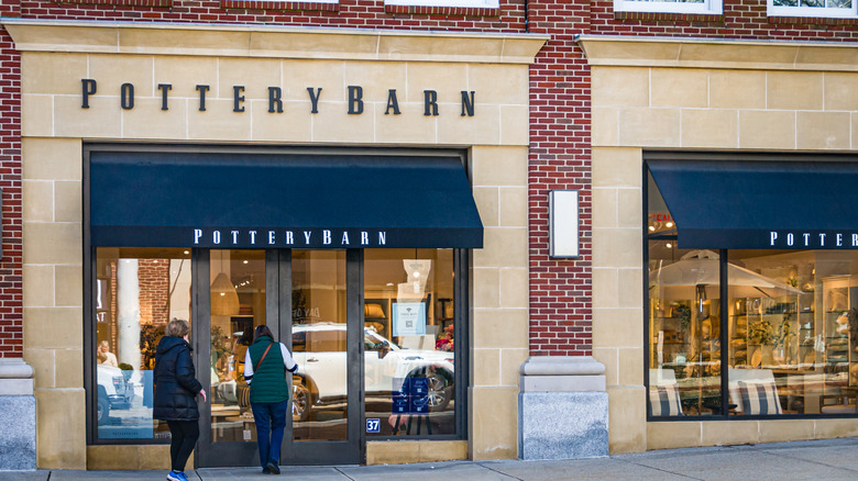 A Pottery Barn store front in a building with a brick facade.