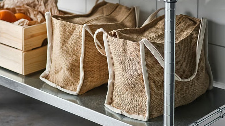GULLRISMOTT beige and white jute food storage bag inside pantry.