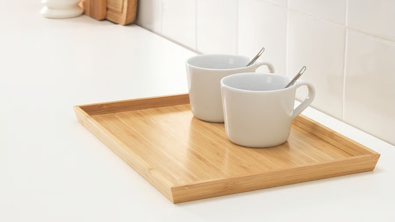 OSTBIT bamboo tray holding two empty white cups