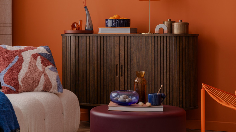 A dark wood cabinet holding decor on top.