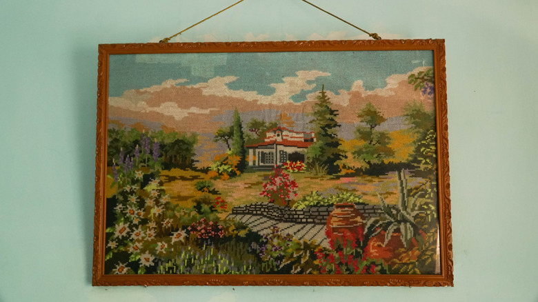A landscape oil painting hun on the wall.