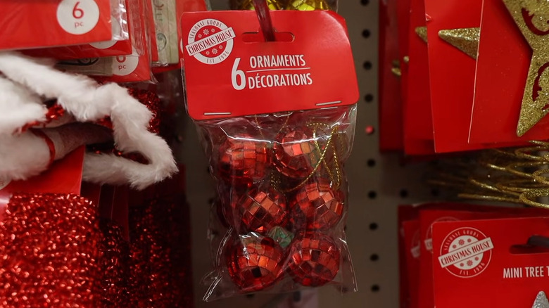 A pack of red disco ball ornaments in a Dollar Tree store