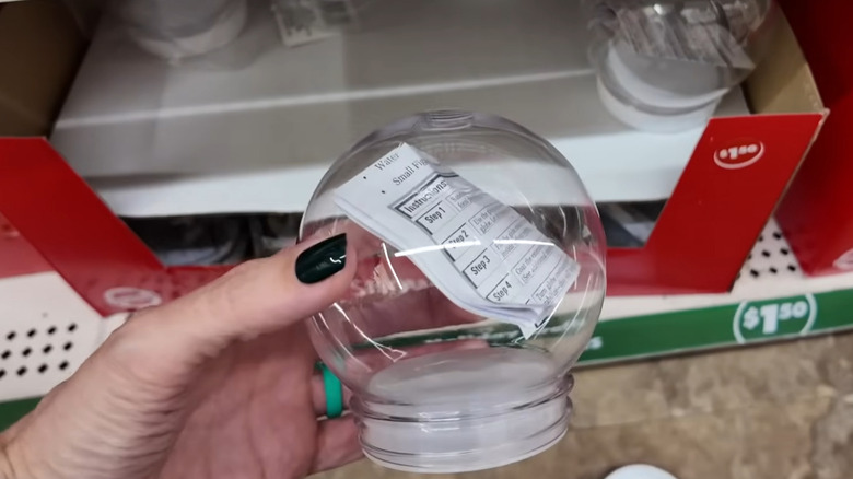 An empty DIY snow globe in a Dollar Tree store.