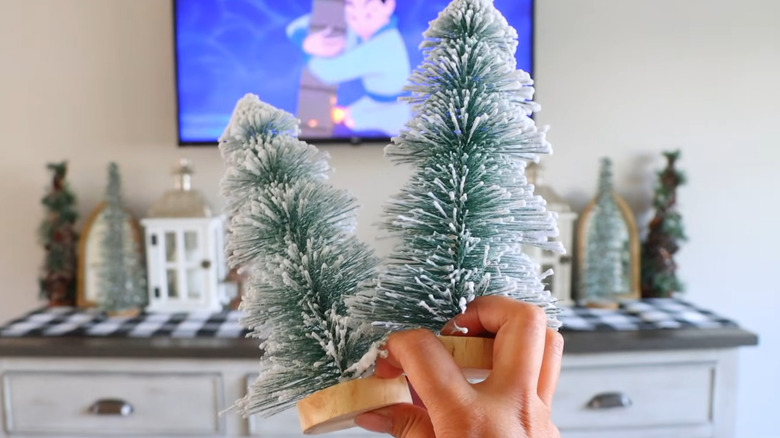 Two flocked mini bottle brush Christmas trees.