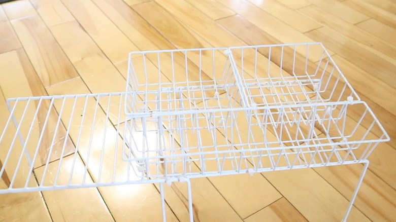 Wire shelves and baskets zip tied together to create storage unit