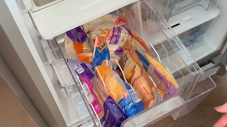 Refrigerator drawer with bags of cheese in a Dollar Tree wire rack