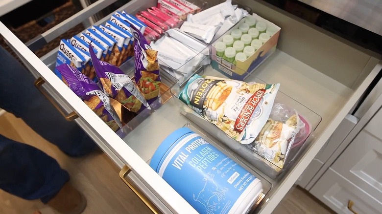 Pantry drawer with snacks organized into acrylic bins from Dollar Tree