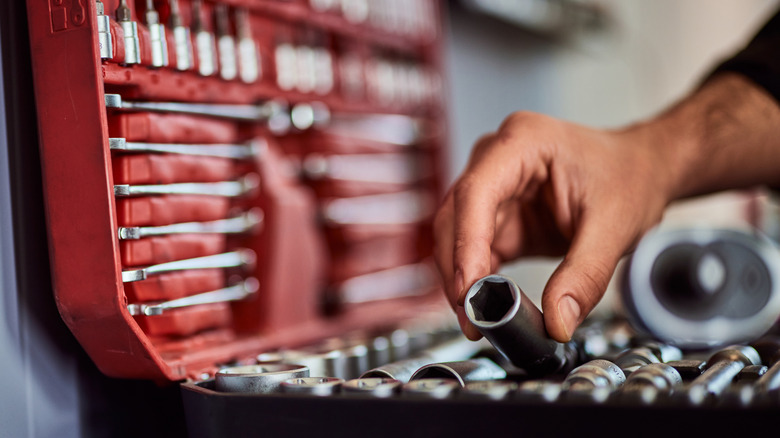 Person holding a socket from a tool set
