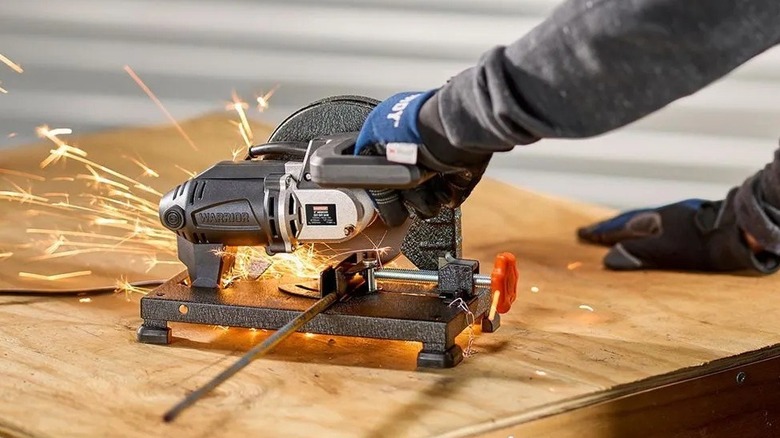 Person using a cut-off saw on metal