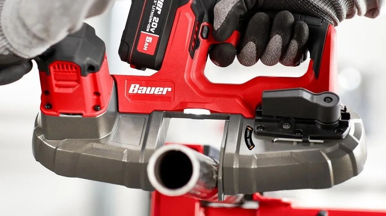 Person using a battery-powered band saw